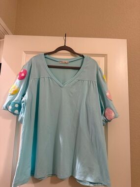 Light Blue V-Neck Top with Pom-Pom Sleeve Accents